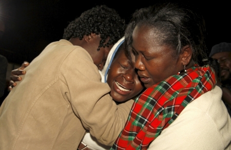 People react after meeting their relative (C) who was rescued from the Garissa University attack at Nyayo stadium in Kenya's capital Nairobi, April 4, 2015, following Thursday's siege by gunmen in their campus in Garissa. Kenya's President Uhuru Kenyatta said on Saturday that those behind an attack in which al-Shabaab Islamist militants killed 148 people at a university were
