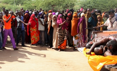 A crowd looks at bodies of suspected Garissa University College attackers in a school compound in Garissa, April 4, 2015. The death toll in an assault by Somali militants on Garissa University College is likely to climb above 147, a government source and media said on Friday, as anger grew among local residents over what they say as a government failure to prevent bloodshed.