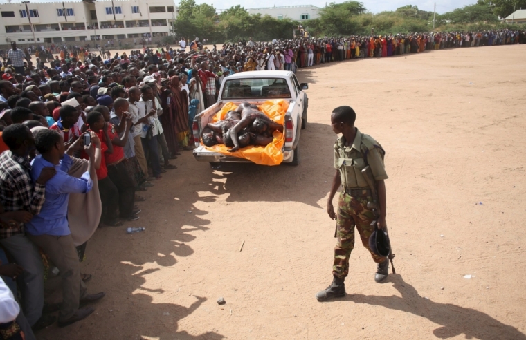 A crowd looks at bodies of suspected Garissa University College attackers in a school compound in Garissa, April 4, 2015. The death toll in an assault by Somali militants on Garissa University College is likely to climb above 147, a government source and media said on Friday, as anger grew among local residents over what they say as a government failure to prevent bloodshed.