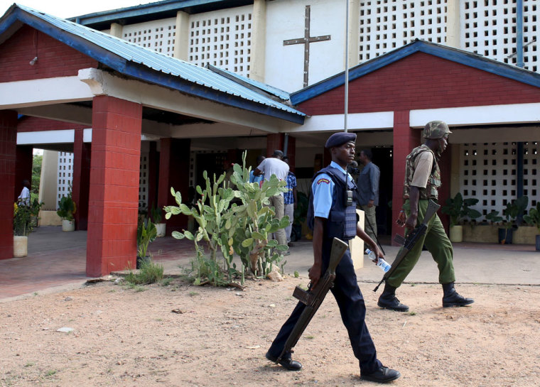 Policemen walk in front of a Catholic church before an Easter Sunday service in Garissa April 5, 2015.