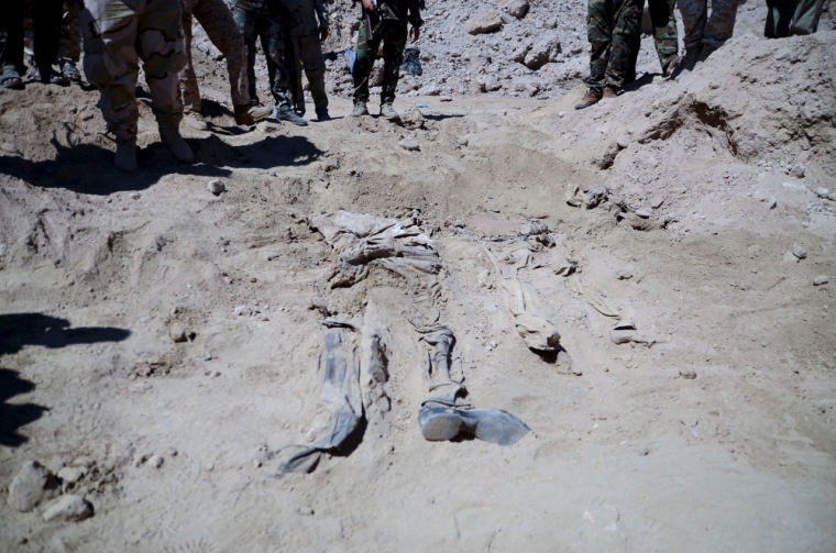Remnants of a body belonging to Shiite soldiers from Camp Speicher who have been killed by Islamic State militants is seen at a mass grave in the presidential compound of the former Iraqi president Saddam Hussein in Tikrit, April 6, 2015. Iraqi forensic teams began on Monday excavating 12 suspected mass grave sites thought to hold the corpses of as many as 1,700 soldiers massacred last summer by Islamic State militants as they swept across northern Iraq.