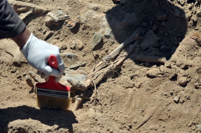 A hand is seen as Iraqi forensic teams recovered dead bodies from a mass grave in the presidential compound of the former Iraqi president Saddam Hussein in Tikrit, April 6, 2015. Iraqi forensic teams began on Monday excavating 12 suspected mass grave sites thought to hold the corpses of as many as 1,700 soldiers massacred last summer by Islamic State militants as they swept across northern Iraq.