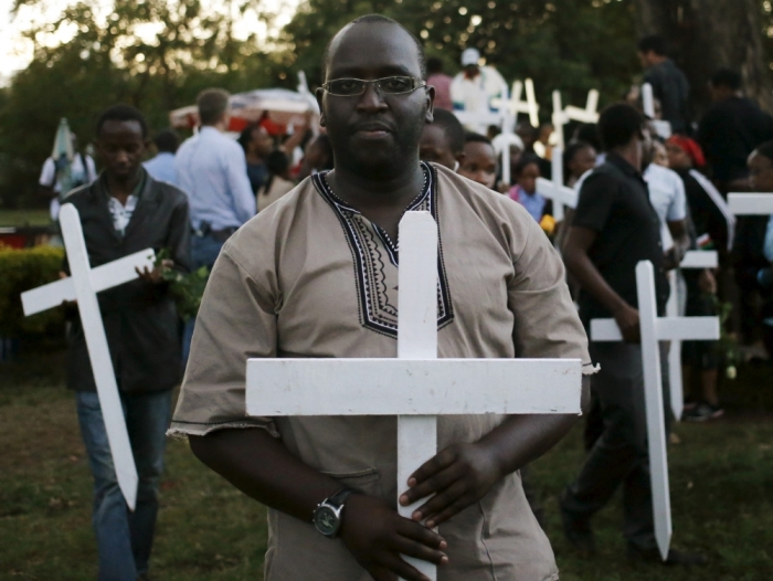 People carry wooden crosses, symbolizing the people killed by gunmen at the Garissa University College, as they arrive for a memorial vigil at the 'Freedom Corner' in Kenya's capital Nairobi, April 7, 2015. 