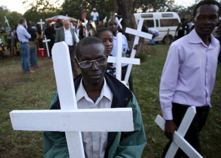 People carry wooden crosses, symbolizing the people killed by gunmen at the Garissa University College, as they arrive for a memorial vigil at the "Freedom Corner" in Kenya's capital Nairobi, April 7, 2015. Kenyan university students marched in the capital on Tuesday to demand more security from the government after gunmen killed nearly 150 people at a campus in the eastern town of Garissa last week. A citizens group planned to hold a vigil in Nairobi's main park later in the evening, tapping growing public frustration over security in the wake of the attack claimed by al-Shabaab Islamists based in neighboring Somalia.