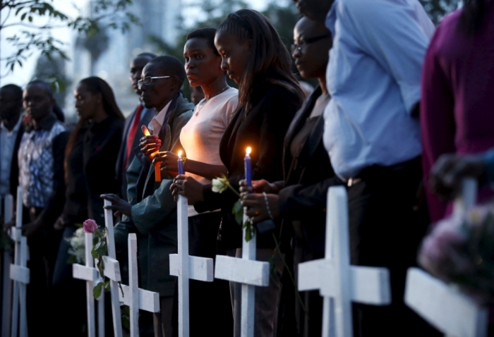Kenyans attend a memorial vigil for the victims of an attack by gunmen at the Garissa University College, at the 'Freedom Corner' in Kenya's capital Nairobi, April 7, 2015. Kenyan university students marched in the capital on Tuesday to demand more security from the government after gunmen killed nearly 150 people at a campus in the eastern town of Garissa last week. A citizens group planned to hold a vigil in Nairobi's main park later in the evening, tapping growing public frustration over security in the wake of the attack claimed by al-Shabaab radical Islamists based in neighboring Somalia.