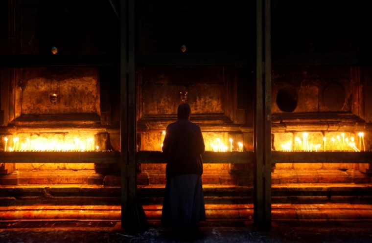 A nun prays by the tomb of Jesus in the Church of Holy Sepulchre in Jerusalem's Old City, November 27, 2009.