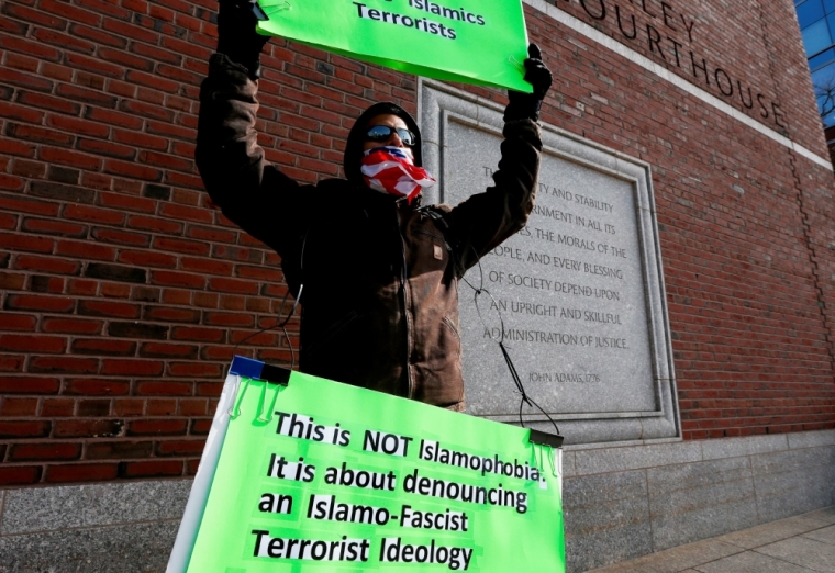 Jose Briceno of Cambridge holds a sign in front of the Moakley federal courthouse where jury deliberations continue in the trial of Boston Marathon bombing suspect Dzhokhar Tsarnaev in Boston, Massachusetts, April 8, 2015. The jurors who will determine if Dzhokhar Tsarnaev is guilty of killing three people and injuring 264 in the 2013 Boston Marathon bombing asked the judge on Wednesday to clarify two legal terms before they began a second day of deliberations.