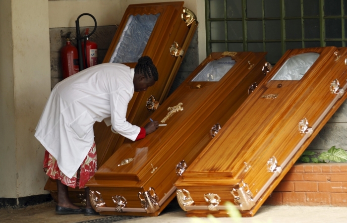 A mortuary worker labels coffins for the students killed during an attack by gunmen at the Garissa University College, at the Chiromo Mortuary in Nairobi, April 8, 2015.