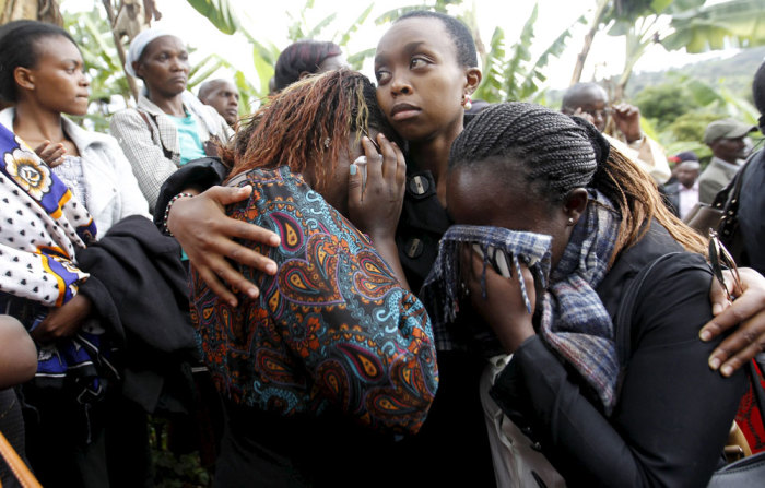 Schoolmates mourn during the burial of Angela Nyokabi, a student killed during an attack by gunmen at Garissa University in Wanugu village, Gatundu near Kenya's capital, Nairobi, April 10, 2015. Days after Islamists killed 148 people at Garissa University, Kenyan President Uhuru Kenyatta extended an olive branch to Muslims urging them to join Nairobi in the struggle against militant Islam by informing on sympathizers.