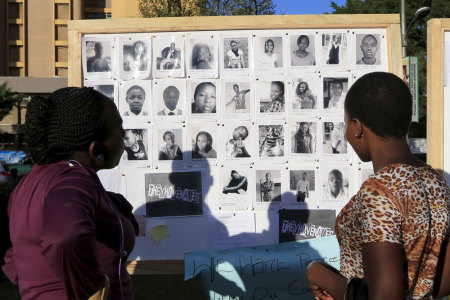 People look a board displaying the pictures of some of the students who were killed by gunmen at Garissa University College, as Kenyans continue to pay their respects at the "Freedom Corner" in Kenya's capital Nairobi April 9, 2015.