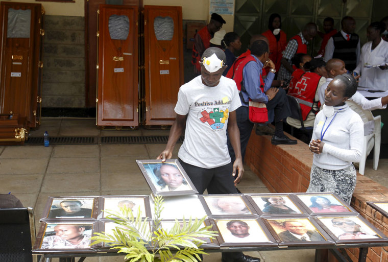 Volunteers arrange pictures of students killed during an attack by gunmen at Garissa University, at the Chiromo Mortuary in the capital Nairobi April 9, 2015. Political pressure mounted on Kenya's president on Wednesday with scathing editorials and growing anger at a seven hour delay in the deployment of a special forces unit that eventually ended the bloody siege at Garissa University last week.