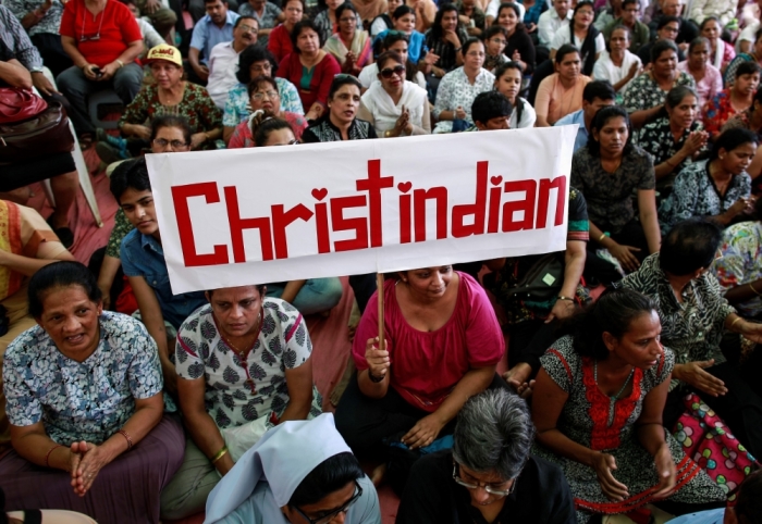 A protester holds a placard during a rally by hundreds of Christians against recent attacks on churches nationwide, in Mumbai, February 9, 2015. Five churches in the Indian capital New Delhi have reported incidents of arson, vandalism and burglary. The latest was reported last week when an individual stole ceremonial items.