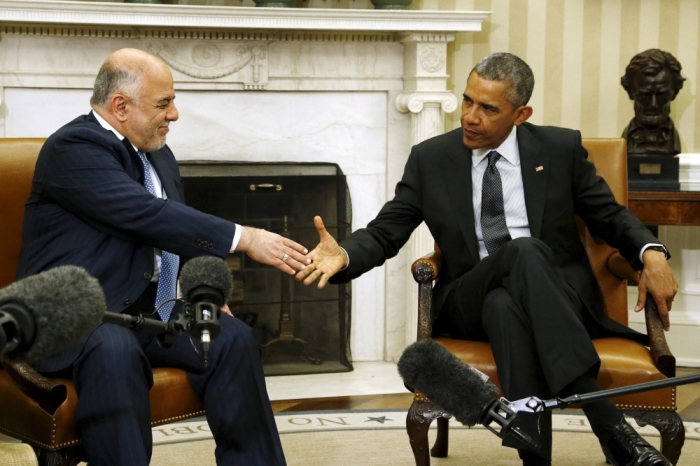 Iraq's Prime Minister Haider al-Abadi (L) and U.S. President Barack Obama shake hands after their bilateral meeting in the Oval Office at the White House in Washington, April 14, 2015. In a warning to Iran, Obama on Tuesday said foreign fighters in Iraq must respect its sovereignty when assisting in the fight against Islamic State militants. Obama, speaking in the Oval Office with al-Abadi, said the two men had discussed Iran's role in Iraq at length.