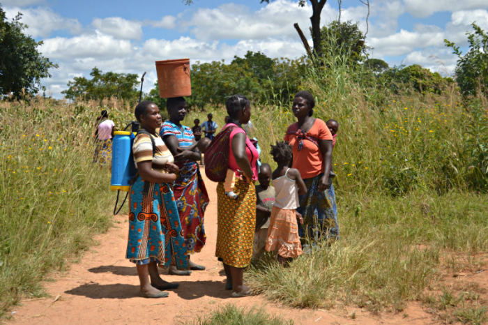 Women talk near a clinic in Bulanda village in Zambia on March 24, 2015.