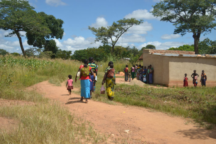 Women talk near a clinic in Bulanda village in Zambia on March 24, 2015.