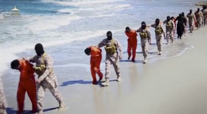 Islamic State militants lead what are said to be Ethiopian Christians along a beach in Wilayat Barqa, in this still image from an undated video made available on a social media website on April 19, 2015.