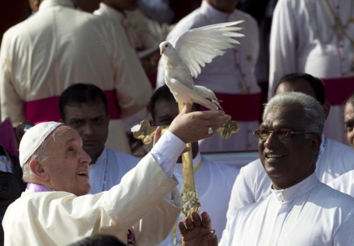 Pope Francis frees a dove in Madhu, Sri Lanka, on Jan. 14. The Catholic leader told reporters Thursday that he believes humans are mostly to blame for climate change.