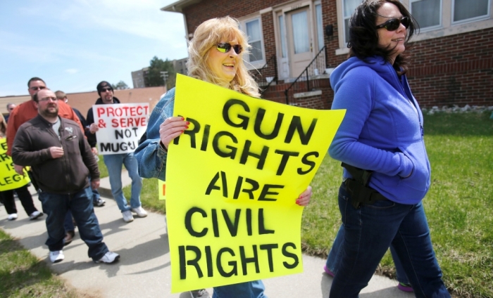 Lavone Olmstead (R) openly carries her Smith & Wesson pistol on her hip during a rally in support of the Michigan Open Carry gun law in Romulus, Michigan, April 27, 2014.