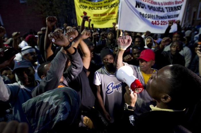 Demonstrators protest outside of the Baltimore Police Department's Western District police station during a rally for Freddie Gray, in Baltimore, Maryland, on Tuesday, April 21, 2015.