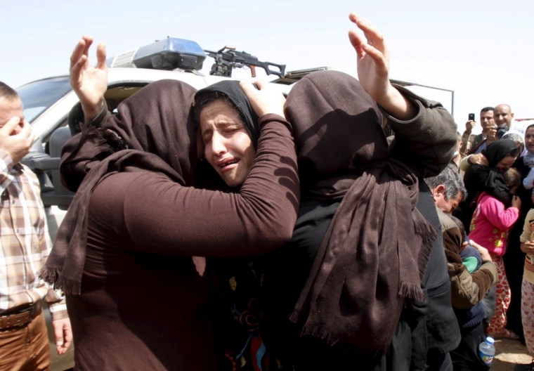 Members of the minority Yazidi sect who were newly released hug each other on the outskirts of Kirkuk, April 8, 2015. More than 200 elderly and infirm Yazidis were freed on Wednesday by Islamic State militants who had been holding them captive since overrunning their villages in northwestern Iraq last summer.