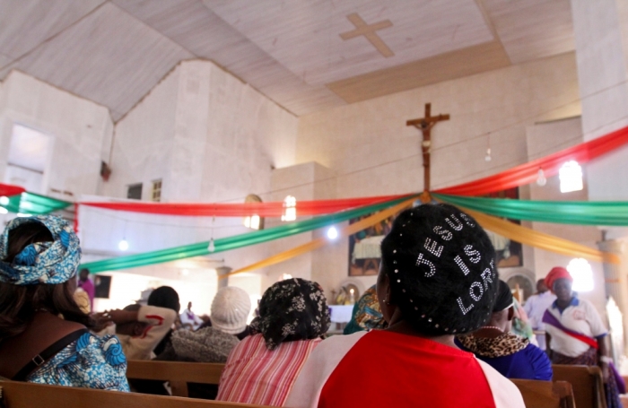 Members attend a memorial church service for victims of a suicide bomb attack at St. Theresa's Church in Madalla, on the outskirts of Nigeria's capital Abuja, December 23, 2012.<br>