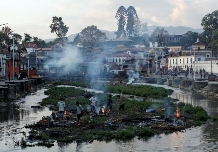 Victims of the earthquake are cremated along a river in Kathmandu, April 27, 2015.