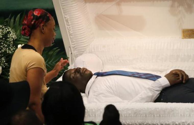 Mourners pay their respects at the open casket of 25-year old Freddie Gray prior to his funeral services at New Shiloh Baptist Church in Baltimore, Maryland, April 27, 2015. Gray died after being taken into police custody and sustaining a mysterious spinal injury, a death that has angered many residents of this predominantly African-American city.