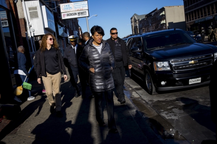 Baltimore mayor Stephanie Rawlings-Blake tours Pennsylvania avenue as Maryland State Police stand guard in Baltimore, Maryland, April 28, 2015. Baltimore erupted in violence on Monday as hundreds of rioters looted stores, burned buildings and at least 15 police officers were injured following the funeral of Freddie Gray, a 25-year-old black man who died after suffering a spinal injury in police custody. The riots broke out blocks from where the funeral of Gray took place and spread through much of west Baltimore.