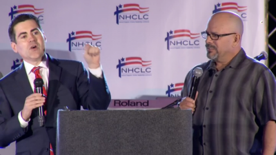 Russell Moore (left), president of the Southern Baptist Convention's Ethics & Religious Liberty Commission, speaking at the National Hispanic Christian Leadership Conference's convention with an English to Spanish translator (right), Houston, Texas, April 28, 2015.