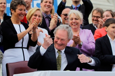 Rhode Island Governor Lincoln Chafee uncaps his pen as he signs the Marriage Equality Act into law at the State House in Providence, Rhode Island, May 2, 2013. Rhode Island became the 10th U.S. state to extend marriage rights to same-sex couples.