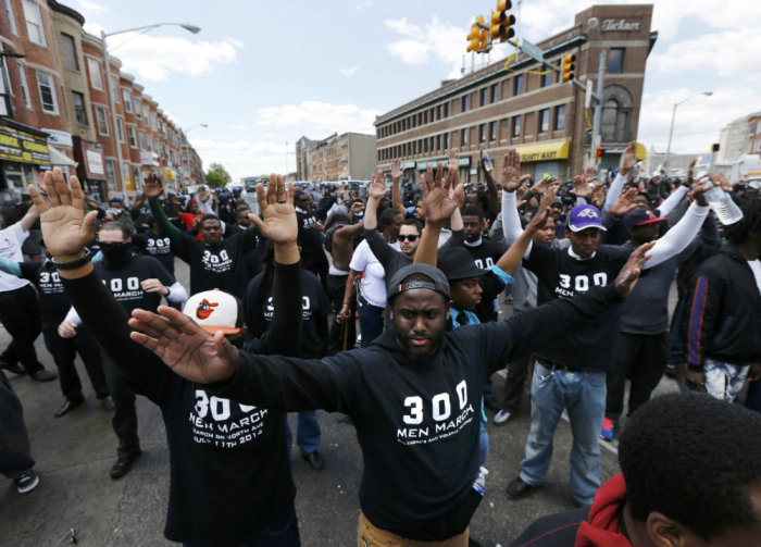 Members of the community stand between demonstrators and police officers after items were thrown and pepper spray used outside a recently looted and burned CVS store in Baltimore, Maryland, April 28, 2015. The day after rioters tore through Baltimore, the city's mayor was criticized on Tuesday for a slow police response to some of the worst U.S. urban unrest in years after the funeral of Freddie Gray, a 25-year-old black man who died in police custody. Maryland Governor Larry Hogan said he had called Mayor Stephanie Rawlings-Blake repeatedly Monday but that she held off calling in the National Guard until three hours after violence first erupted.