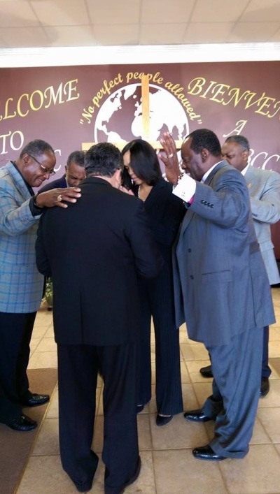 Baltimore state's attorney Marilyn Mosby prays with church leaders, including Bishop Angel Nunez, during a prayer breakfast in Baltimore, Maryland, on April 28, 2014