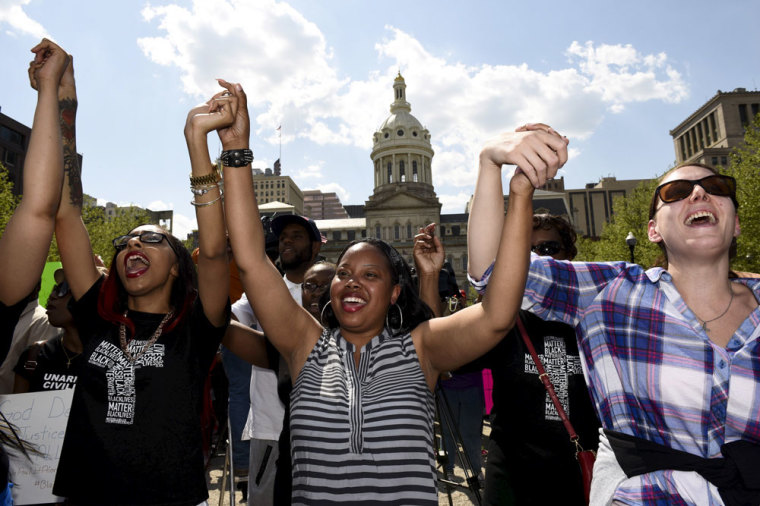 People cheer during a religious rally for Freddie Gray in front of the City Hall in Baltimore, May 3, 2015. Baltimore's Mayor Stephanie Rawlings-Blake on Sunday lifted a night curfew imposed on the city last week to stem a spate of looting and arson that followed the funeral of 25-year-old black man Freddie Gray who died from injuries suffered while in police custody.
