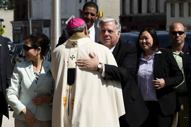 Governor Larry Hogan shakes hands with Archbishop William E. Lori in front of St. Peter Claver Catholic Church in Baltimore, May 3, 2015. Baltimore's Mayor Stephanie Rawlings-Blake on Sunday lifted a 10 p.m. to 5 a.m. curfew she had imposed on the city last week after a night of looting and arson that followed the death of 25-year-old Freddie Gray from injuries suffered while in the police custoday. Hogan called for a day of prayer and reconciliation on Sunday.