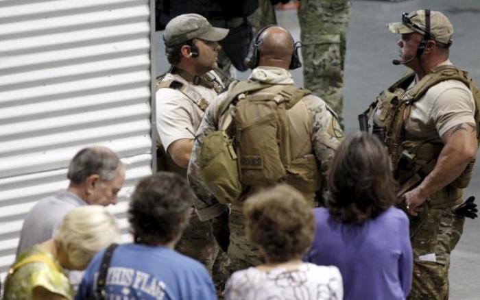 Police officers stand guard at an entrance as attendees are prevented from leaving the Muhammad Art Exhibit and Contest after it was reported that shots were fired outside the venue and a man is down in Garland, Texas, May 3, 2015.