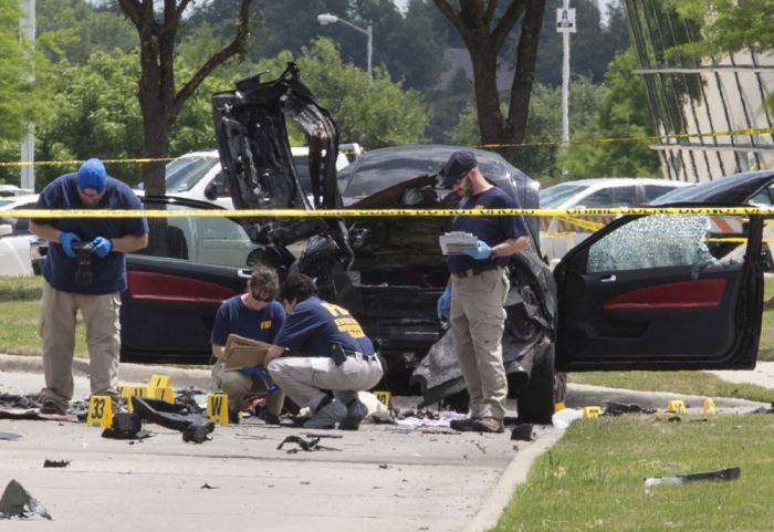 Local police and FBI investigators collect evidence and survey the scene where two gunmen were shot dead, after their bodies were removed in Garland, Texas, May 4, 2015. Texas police shot dead two gunmen who opened fire on Sunday outside an exhibit of caricatures of the Prophet Muhammad that was organized by a group described as anti-Islamic and billed as a free-speech event.