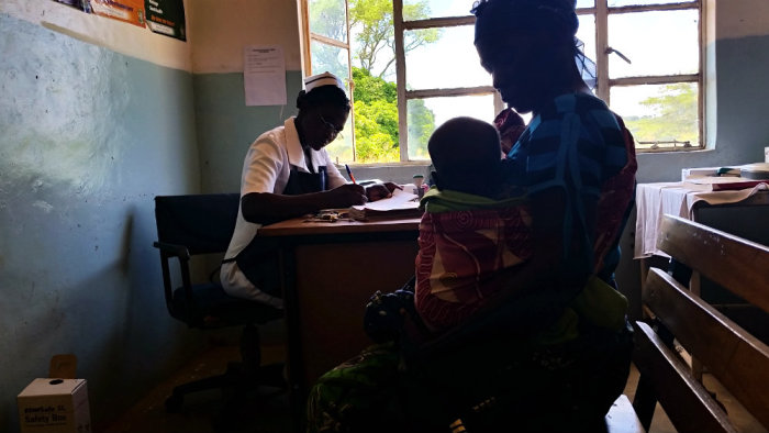 Nurse Bertha Hamaanga, 28, checks up on a mother and her young child on March 25, 2015, at the Moyo ADP Health Center in Southern Zambia.