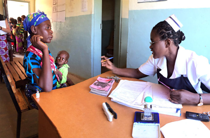 Nurse Bertha Himaanga talks with an HIV-positive mother during a check up at the Moyo ADP Health Center on March 25, 2015, in Southern Zambia.