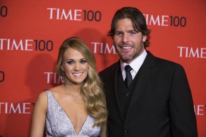 Honoree and singer Carrie Underwood arrives with her husband Mike Fisher at the Time 100 gala celebrating the magazine's naming of the 100 most influential people in the world for the past year, in New York April 29, 2014.