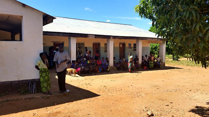 People are seen waiting outside the Moyo ADP Health Center in this photo taken on March 25, 2015.