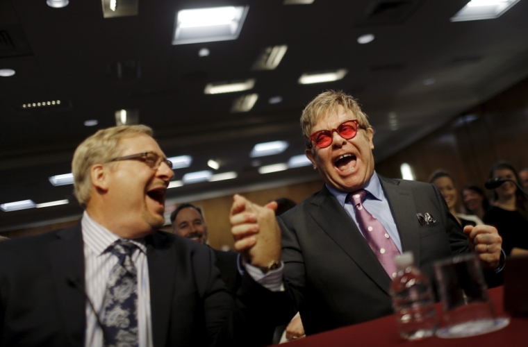 Singer Elton John (R), founder of the Elton John AIDS Foundation, and pastor Rick Warren react as they arrive to testify before a Senate Appropriations State, Foreign Operations and Related Programs Subcommittee hearing on global health problems in Washington, May 6, 2015.