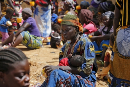 Credit : A woman reflects while feeding her baby at a registration centre in Geidam stadium, Nigeria, May 6, 2015. Niger has evacuated Nigerians living around Lake Chad, military and aid officials told Reuters on Tuesday, as the armies of four west African nations