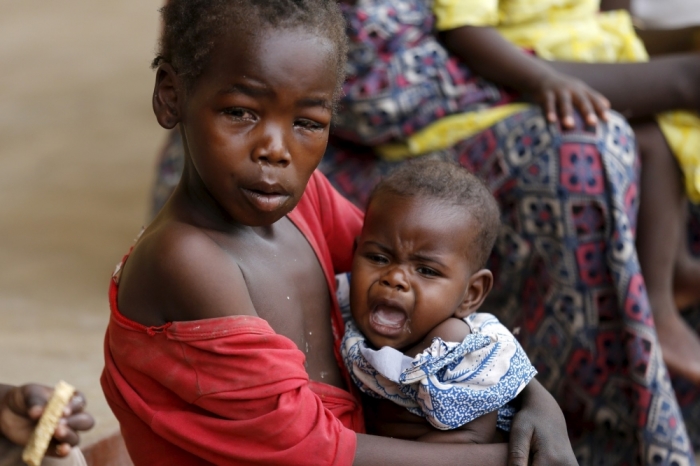 A child rescued from Boko Haram in Sambisa forest carries a baby in front of a clinic at the Malkohi camp for Internally Displaced People in Yola, Adamawa State, Nigeria, May 3, 2015. Hundreds of traumatised Nigerian women and children rescued from Boko Haram Islamists have been released into the care of authorities at a refugee camp in the eastern town of Yola, an army spokesman said.