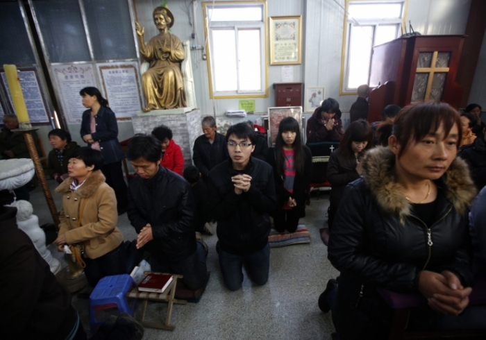Believers take part in a weekend mass at an underground Catholic church in Tianjin November 10, 2013.