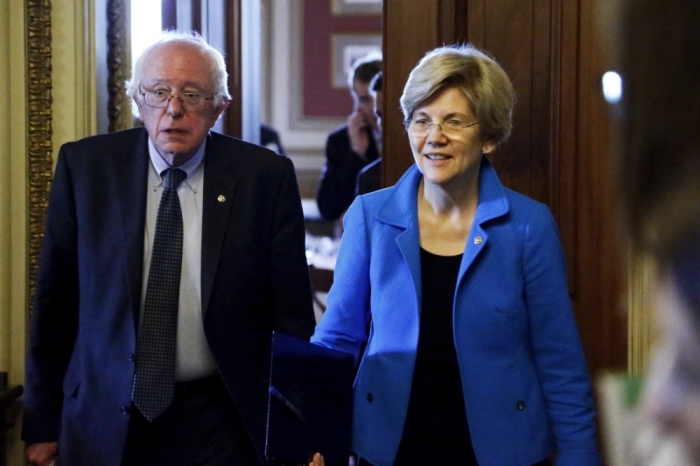 U.S. Senators Bernie Sanders, I-Vt., (L) and Elizabeth Warren, D-Mass., walk to the Senate floor after the weekly Democratic caucus policy luncheon at the U.S. Capitol in Washington May 12, 2015.