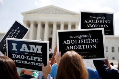 Anti-abortion protestors celebrate the U.S. Supreme Court's ruling striking down a Massachusetts law that mandated a protective buffer zone around abortion clinics, outside the Court in Washington, June 26, 2014. On a 9-0 vote, the court said the 2007 law violated the freedom of speech rights of pro-life protesters under the First Amendment of the U.S. Constitution in preventing them from standing on the sidewalk and speaking to people entering the clinics.