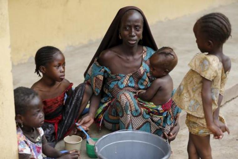 A woman, who was freed by the Nigerian army from Boko Haram militants in the Sambisa forest, feeds her child at the Malkohi camp