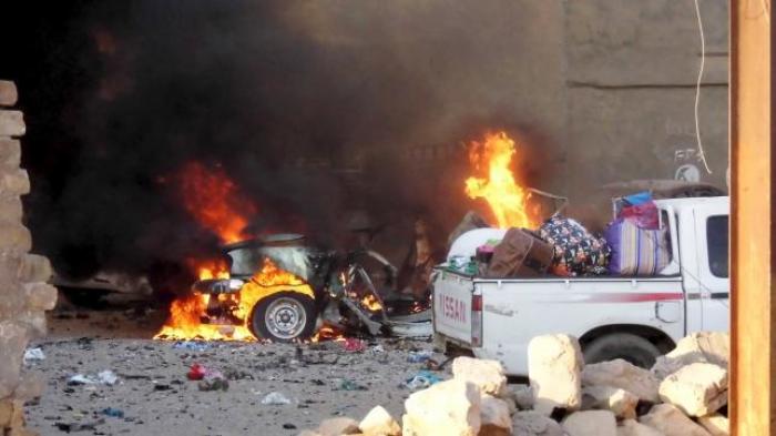 A car is engulfed by flames during clashes in the city of Ramadi, May 16, 2015.
