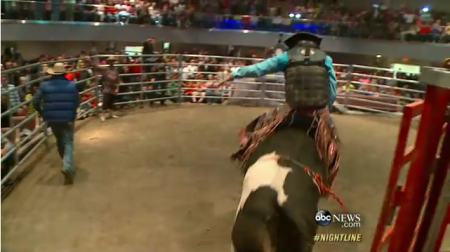 Pastor Lawrence Bishop II riding a bull inside the sanctuary at Solid Rock Church in Monroe, Ohio.