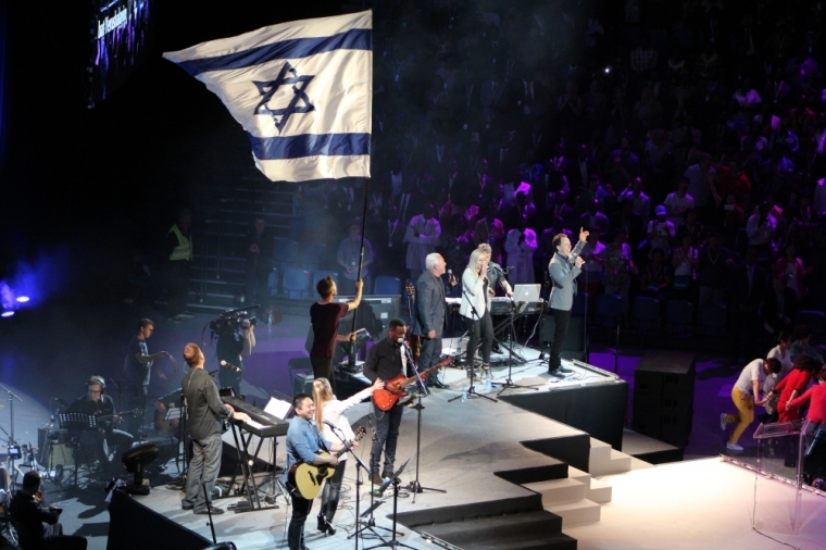 A global group of popular Christian singers and musicians perform as the Israeli flag is presented at the Empowered21 Congress in Jerusalem Israel on May 20, 2015.